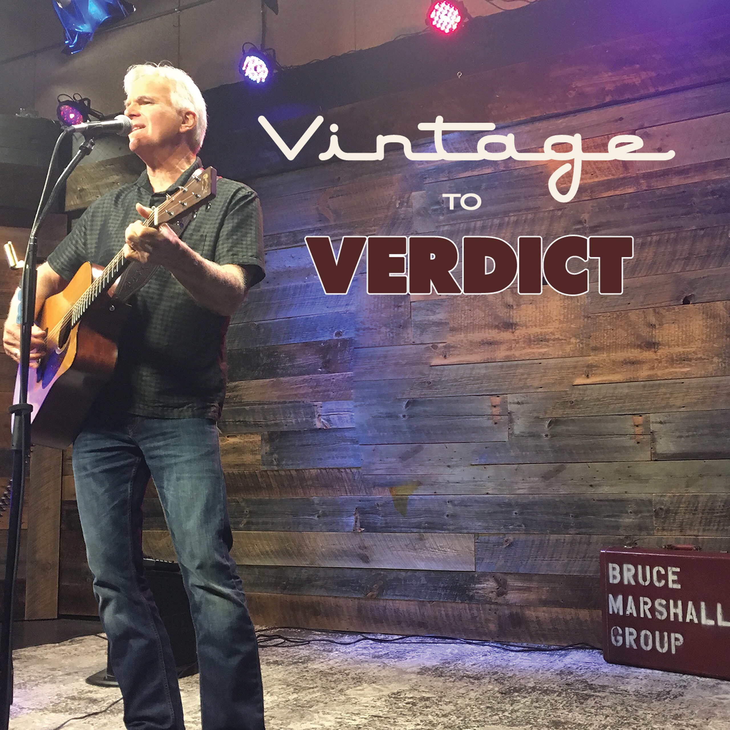 Album cover with text "Vintage to Verdict"; by the Bruce Marshall Group; featuring Bruce playing acoustic guitar on stage while singing into a microphone on the far left.